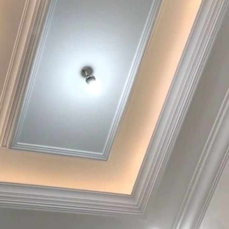 Gypsum ceiling with cove lighting and recessed spotlights