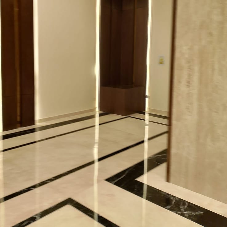 Painted wall finish in a marble-floored corridor