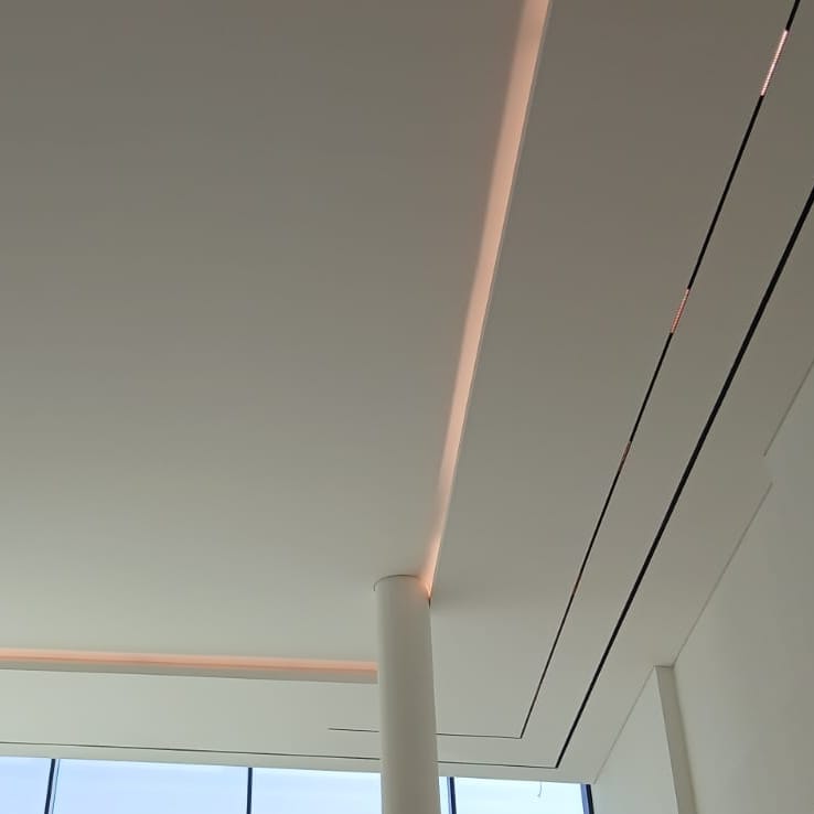 Marble flooring with cove-lit ceiling in a villa corridor