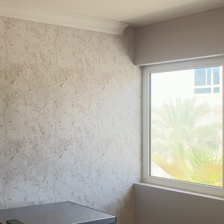 Botanical branch pattern wallpaper in a bright bedroom