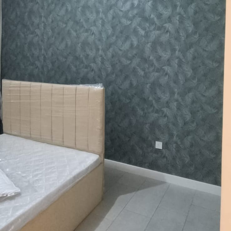 Dark leaf-pattern wallpaper installed in a bedroom
